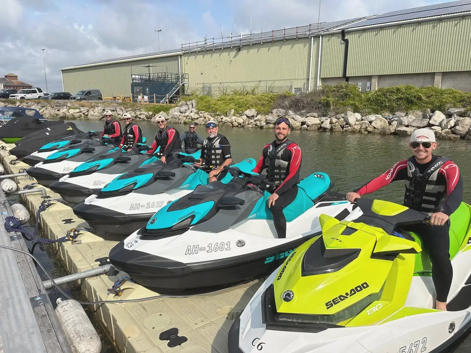 Team lined up on jet skis at Poole Harbour dock