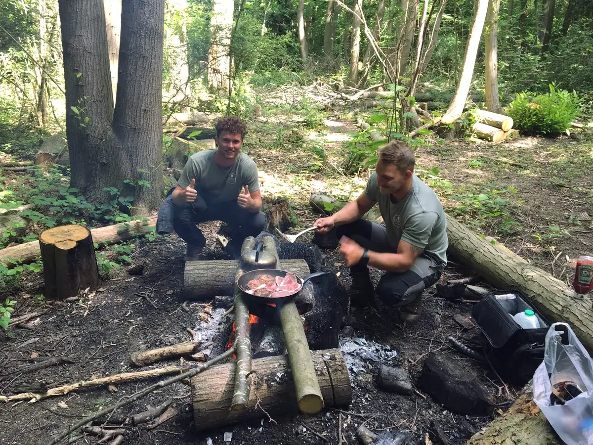 Crew lunch around a campfire