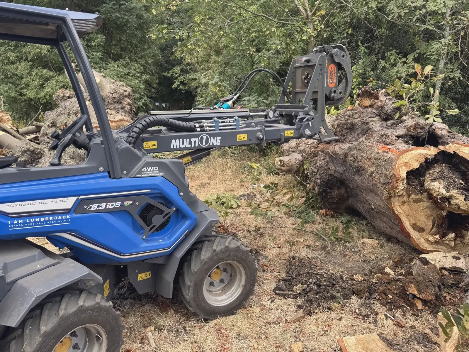 Our Multi-One 6.3 mini loader with log grab moving a fallen trunk